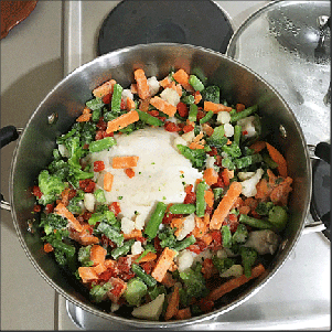 Frozen mixed veggies added to the almost fully cooked chicken.